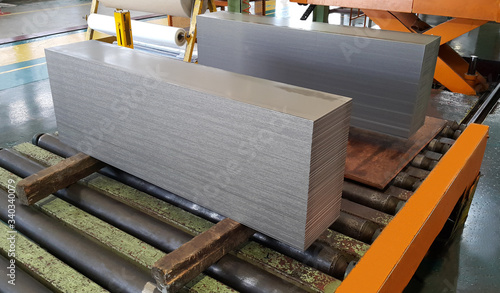 Steel sheet cutting on the conveyor, sheared metal sheet industry