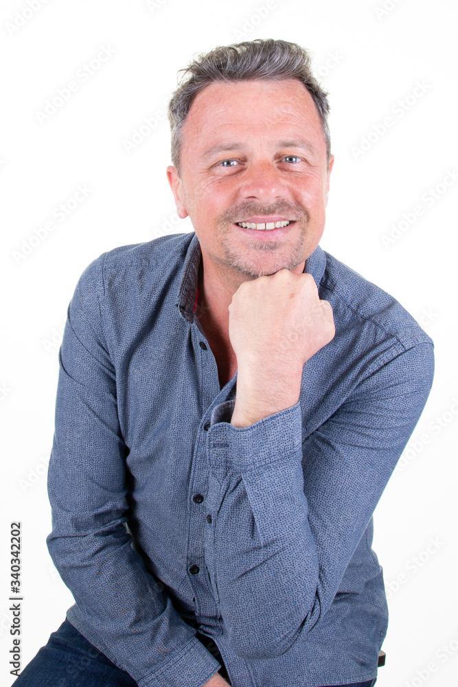 Portrait attractive cheerful glad content mature guy self-employed freelancer hand on chin isolated over bright white background Portrait attractive cheerful glad content mature guy self-employed freelancer hand on chin isolated over bright white background