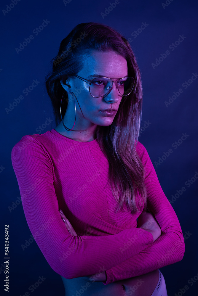 Woman in neon light dancing in the club Woman in neon light dancing in the club