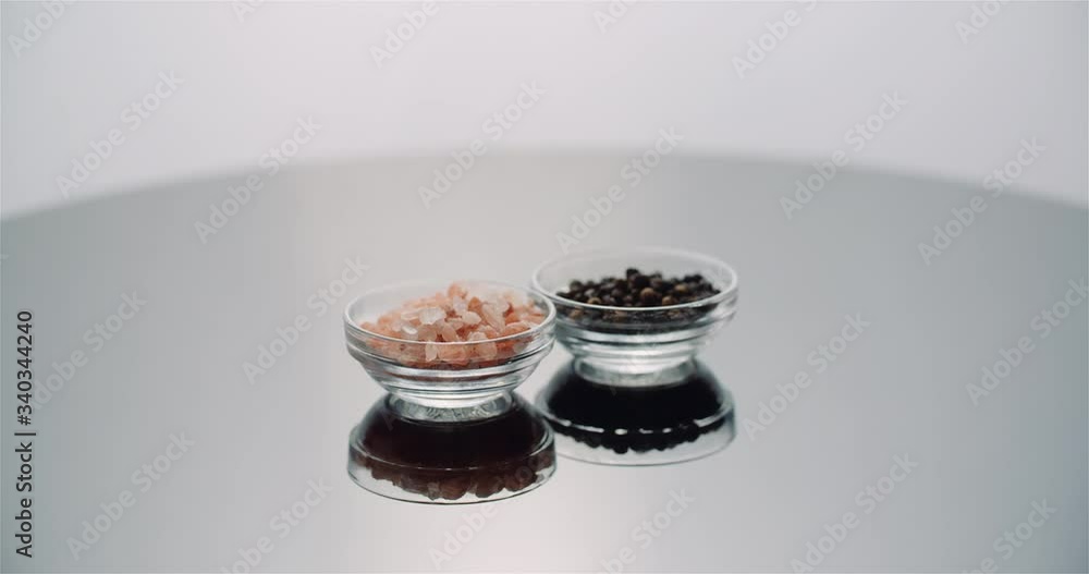 Pepper and Himalayan Salt in bowl Rotating on table Pepper and Himalayan Salt in bowl Rotating on table