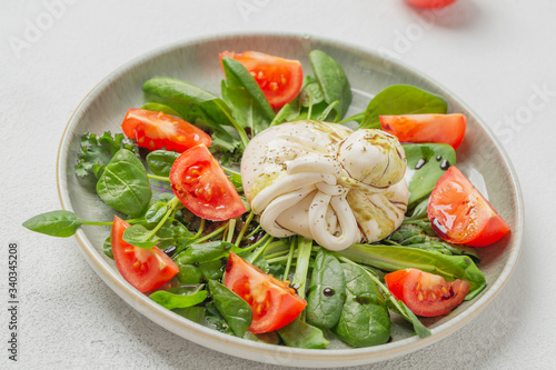 Burrata cheese. Salad with Italian burrata cheese, balsamic and cherry tomatoes.