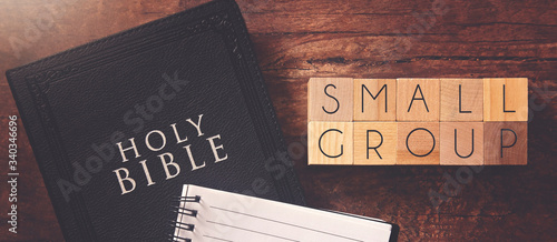 Small Group in Block Letters on a Wooden Table with a Holy Bible photo