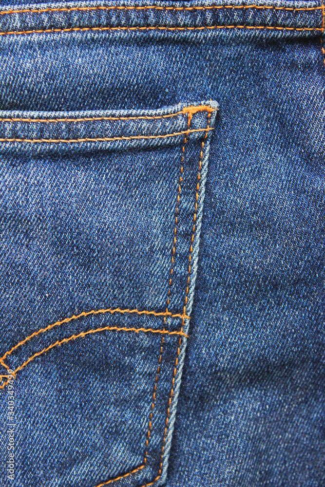 Denim jeans pocket detail, vertical dark blue jeans fabric close up. Modern simple jean fabric, seams pattern on dark blue denim pants background material detail Denim jeans pocket detail, vertical dark blue jeans fabric close up. Modern simple jean fabric, seams pattern on dark blue denim pants background material detail