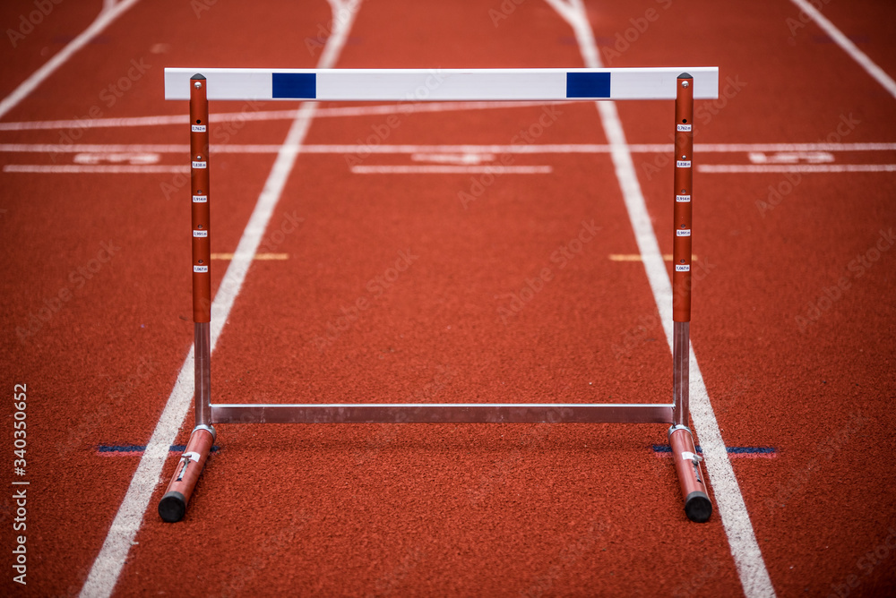 Hurdle on race track, track and field equipment Photos Adobe Stock