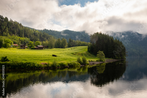 Fotografie A farm with traditional wooden buildings on the Telemark Canal in Norway