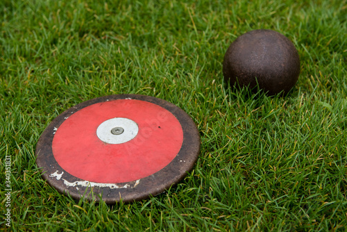 Discus and shot put on the grass, track and field equipment