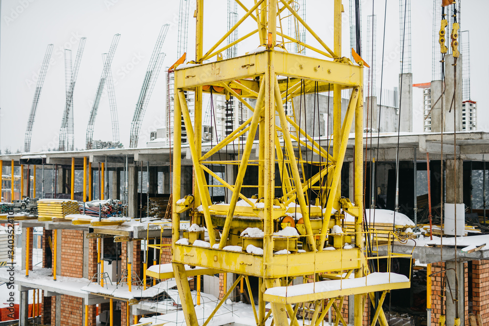 the construction of new walls in the construction of a residential building with a crane the construction of new walls in the construction of a residential building with a crane