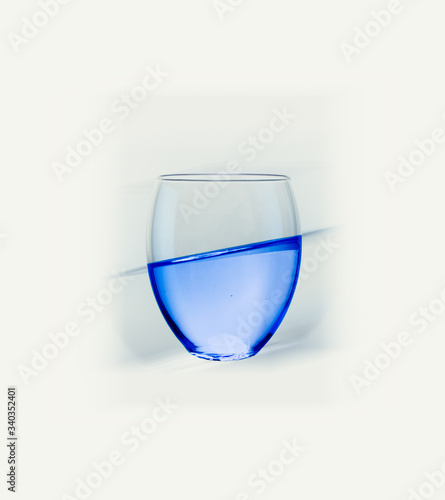 Isolated glass with blue liquid