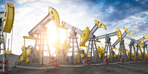 Foto Oil pump jack imn a row. Oil production and extraction concept.