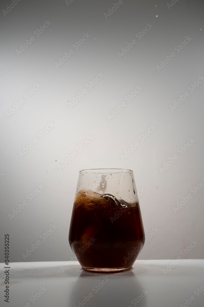 juice splash in a drinking glass juice splash in a drinking glass