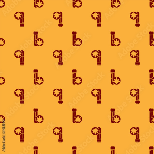 Red Chemical test tube with marijuana or cannabis leaf icon isolated seamless pattern on brown background. Research concept. Laboratory CBD oil.  Vector Illustration
