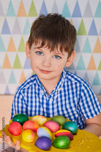 Different color Easter Eggs in a child's hands- egg hunt.