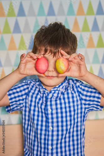 Different color Easter Eggs in a child's hands- egg hunt.