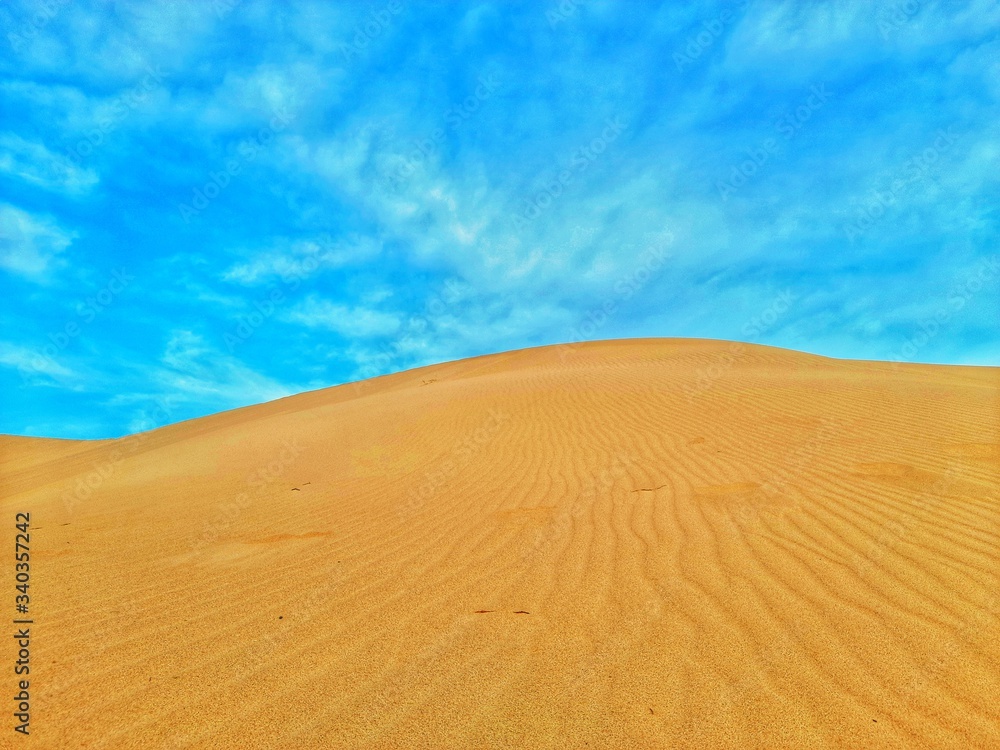 Sand dune in desert and blue sky