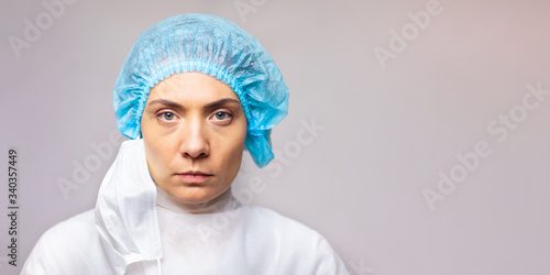 serious look woman doctor in medical uniform is looking at the camera, close-up portrait. copy space. space for text or logo