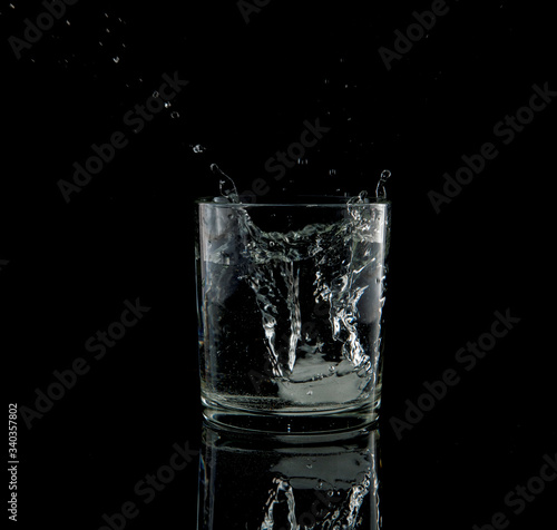 splash from a falling ice cube in glass of water