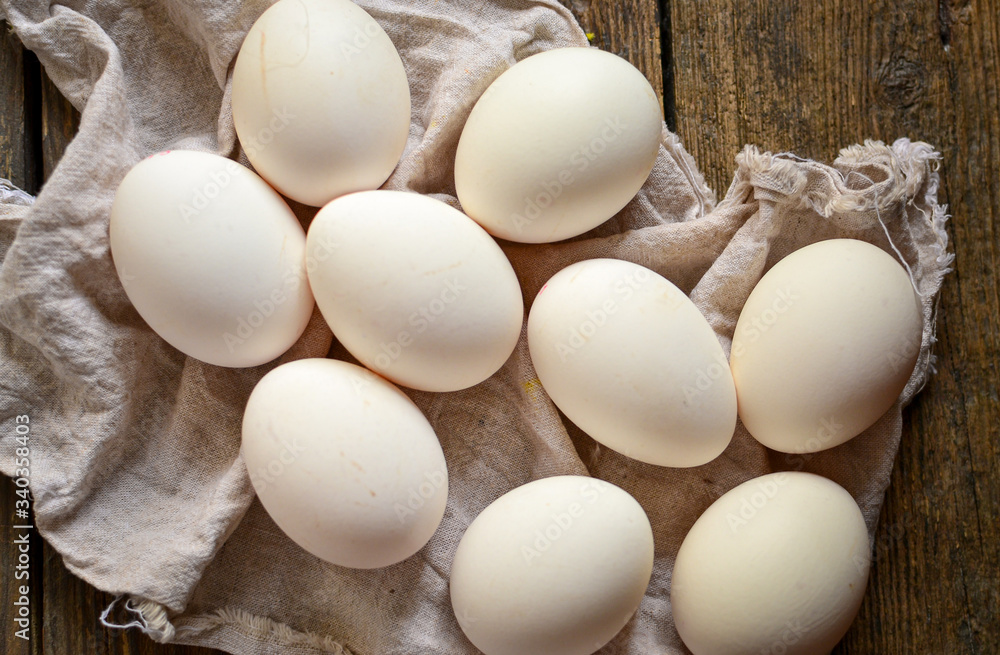 Raw whole eggs on a wooden background. Top view. Dark background. Free space for text. Healthy breakfast. Raw whole eggs on a wooden background. Top view. Dark background. Free space for text. Healthy breakfast.