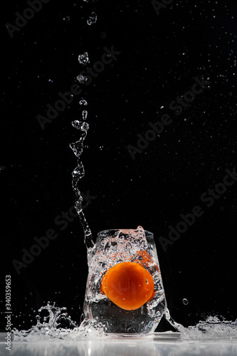 tomato water splash in a drinking glass
