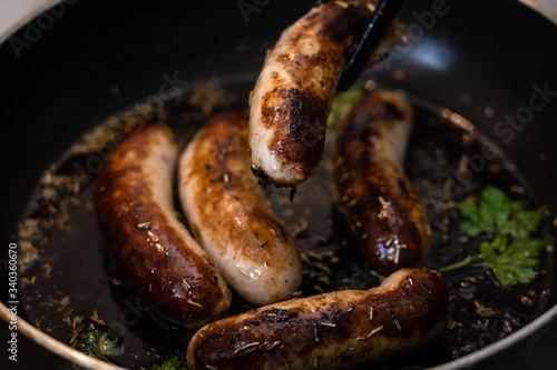 hunting sausages fried in a pan with spices