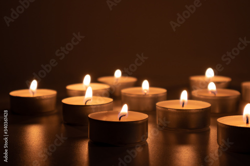 Burning small candles in the dark, spirituality scene, darkness