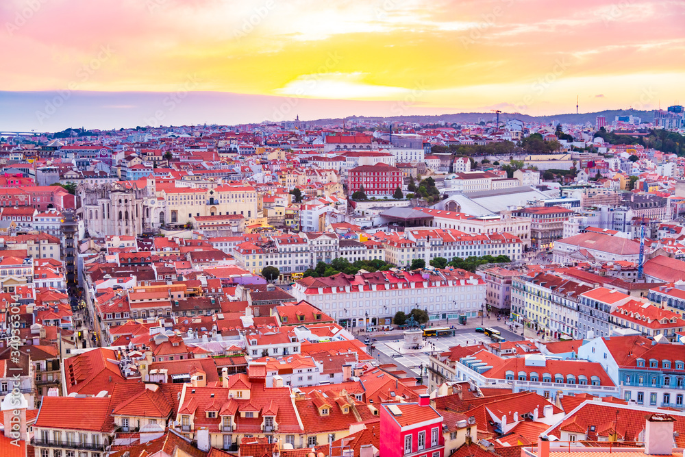 Fototapeta premium Beautiful panorama of old town and Baixa district in Lisbon city during sunset, seen from Sao Jorge Castle hill, Portugal
