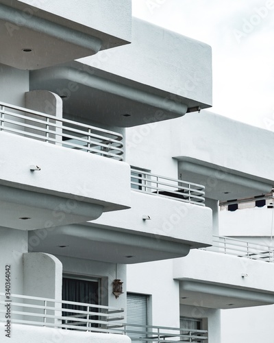 Fotografia, Obraz Vertical shot of the white building with several balconies