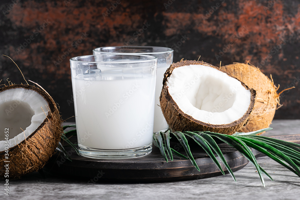 Fresh non dairy coconut drink on dark rustic background close up. Fresh non dairy coconut drink on dark rustic background close up.