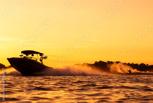 Boating at sunset with a Wakeboarder in florida