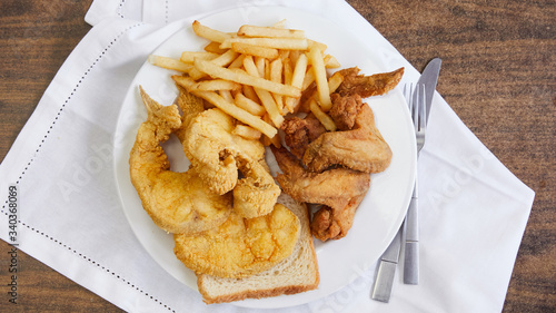 A classic southern style plate of chicken, fish and fries