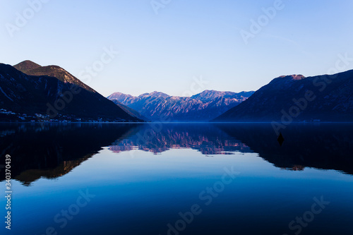 Bay of Kotor, Montenegro Sunrise with Light on Mountains and Reflection in Still Water