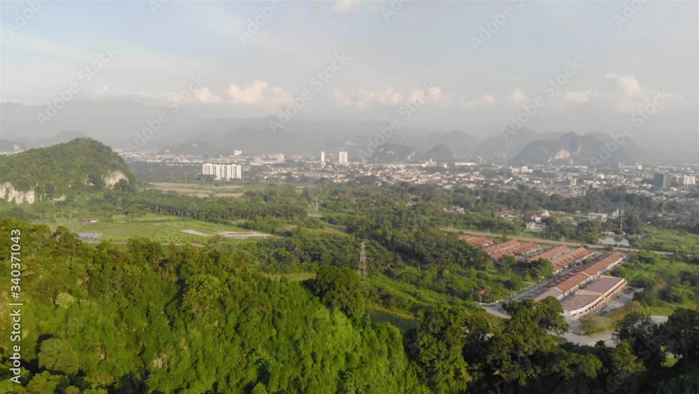 View of hills and city with mist covered mountain - Pan left - Dolly Backwards View of hills and city with mist covered mountain - Pan left - Dolly Backwards