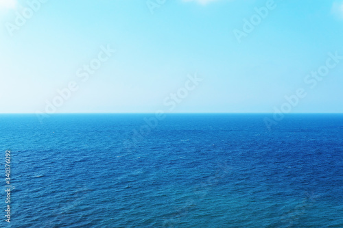 Blue sky over the sea with reflection. Peaceful sea of harmony texture to the water.
