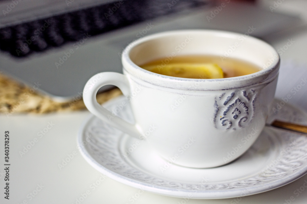 White cup of tea with lemon slice close-up. Homemade cozy tea White cup of tea with lemon slice close-up. Homemade cozy tea