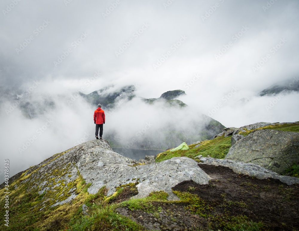 foggy mountains on Lofoten with hiker