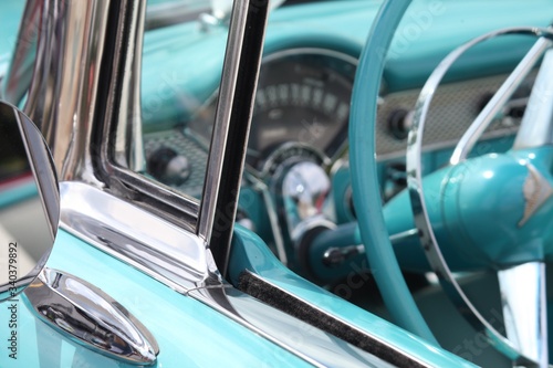 SIDE OF A VINTAGE CAR, COLLECTORS, BLUE, CLASSIC, ANTIQUE, STEERING WHEEL