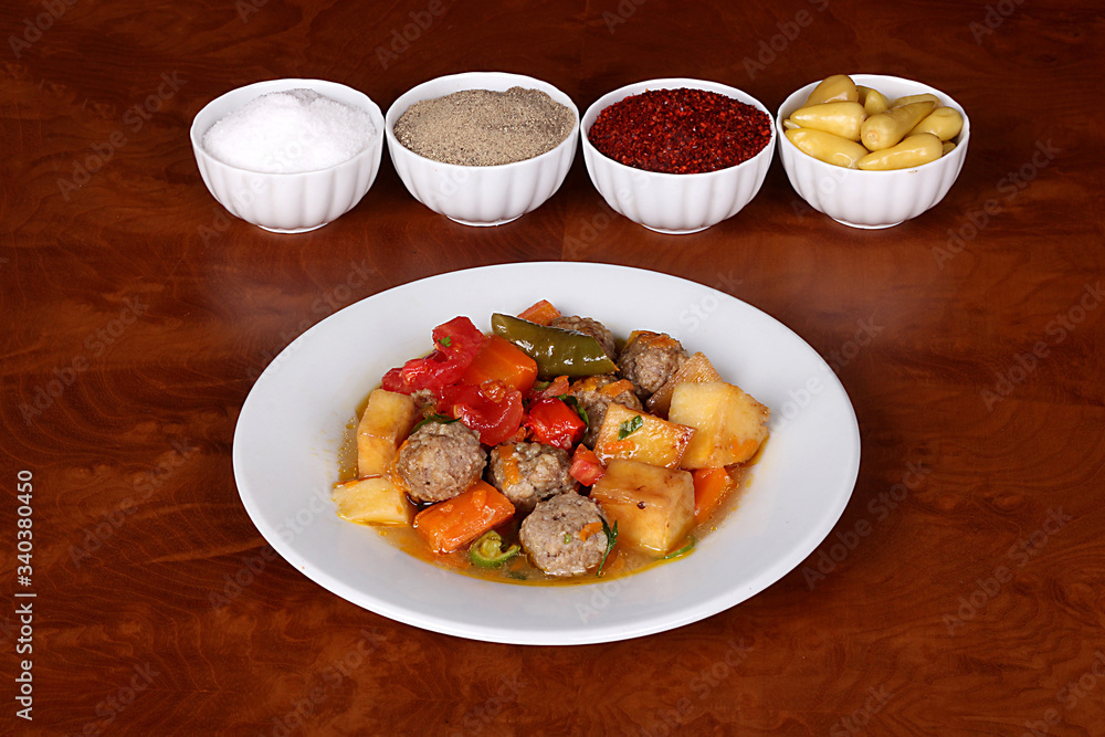 excellent turkish food with meatballs with vegetables, spicy white plate on wooden table