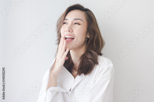 happy and funny woman wearing the white shirt laughs at home