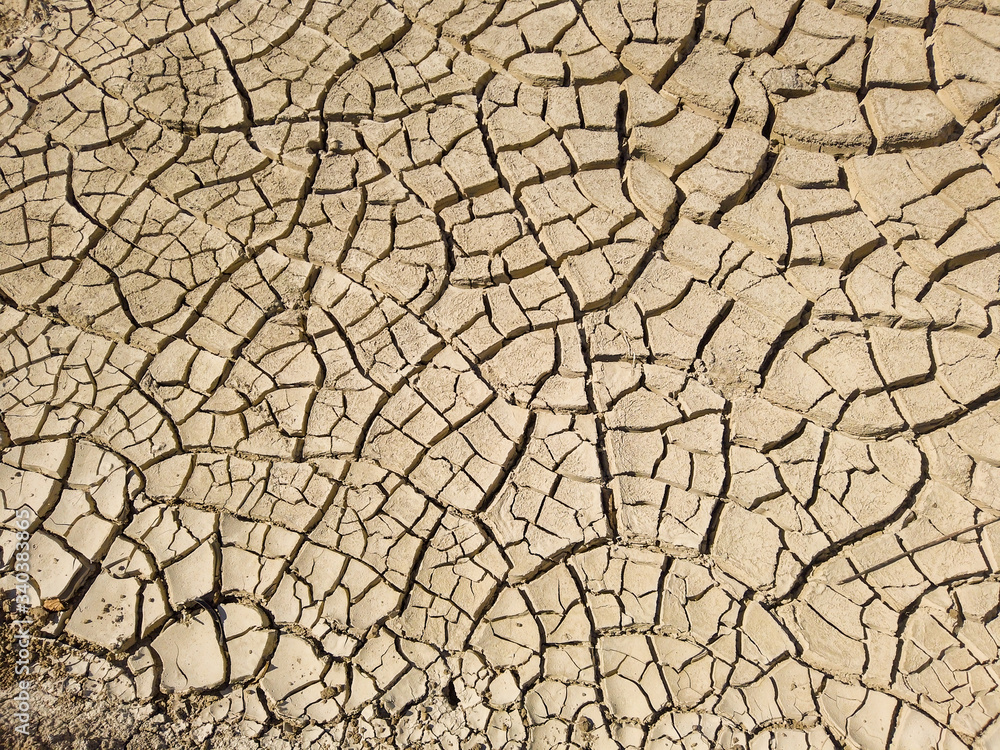 Overhead top view of dry arid soil with cracks during intense heat. Lack of water on agriculture field. Concept of global warming. Overhead top view of dry arid soil with cracks during intense heat. Lack of water on agriculture field. Concept of global warming.