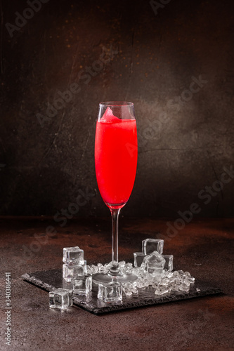 Delicious cold refreshing red smoothie drink in cocktail glass photo