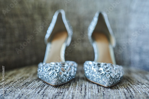fashionable expensive silver grey high heels on a textured surface