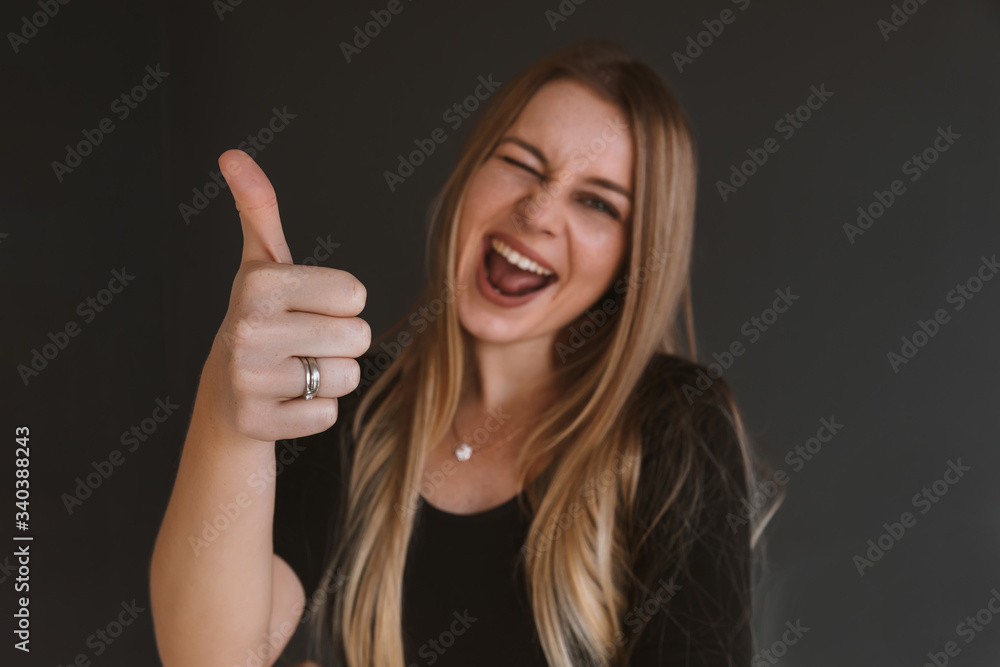 Happy young woman giving thumb up. selective focus Happy young woman giving thumb up. selective focus
