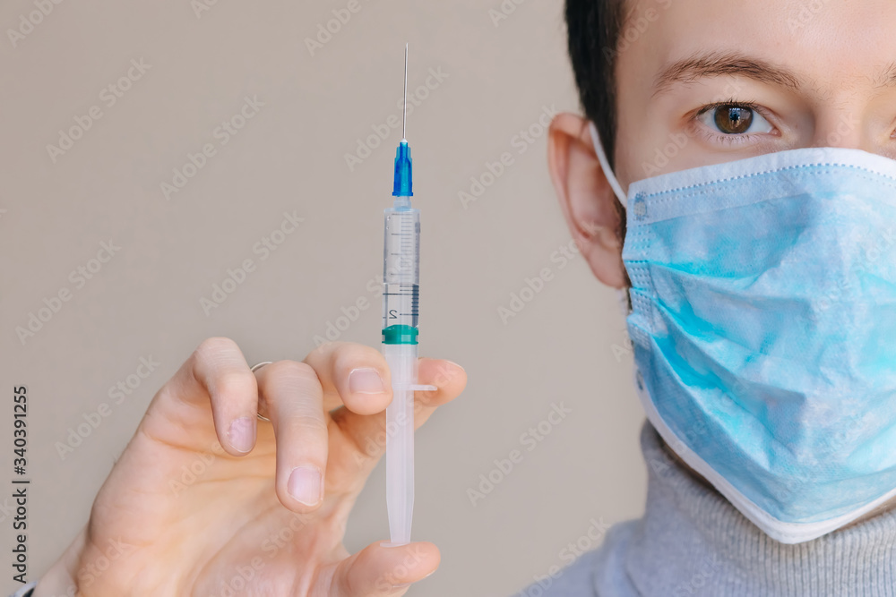Male person in white glove hold vaccine bottle with syringe. Inj Male person in white glove hold vaccine bottle with syringe. Inj
