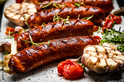 Serving Grilled Barbecue Sausage with BBQ Vegetables and Herbs