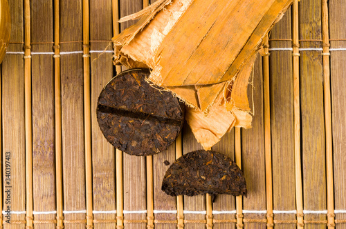 Chinese pressed PU-erh tea in bamboo leaf packaging, close-up, macro photo