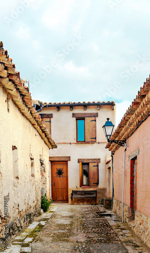 Street of town of Valladolid in the north of Spain in a cloudy day  It  s a medieval village.