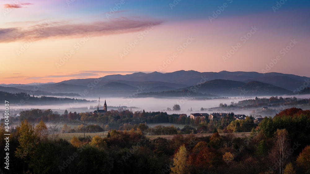 Panoramic view of the Lutowiska (a village in Bieszczady County, in the Subcarpathian Voivodeship of south-eastern Poland) at autumn sunrise. Bieszczady Mountains in the background.