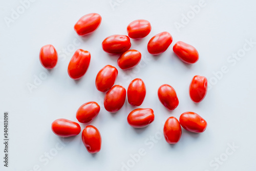 Fresh cherry tomatoes on a white background. Food isolate. Group of fresh tomatoes.