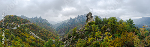 Panoramic view of Pietrapertosa hills under overcast sky, elected most beautiful village, famous for the world's longest zip line and mountain landscapes, in Basilicata, Italy
