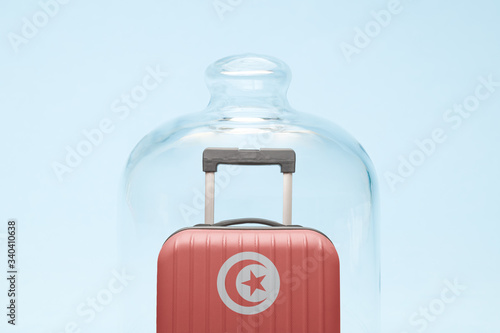 Luggage in isolation under glass cover covid-19 Tunisia tourism abstract.