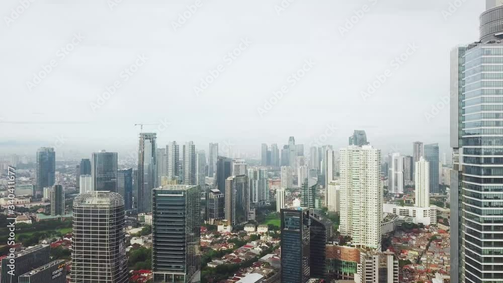 JAKARTA - Indonesia. April 14, 2020: Aerial scenery of beautiful skyscrapers with air pollution in Jakarta downtown at morning time from a drone flying forwards. Shot in 4k resolution JAKARTA - Indonesia. April 14, 2020: Aerial scenery of beautiful skyscrapers with air pollution in Jakarta downtown at morning time from a drone flying forwards. Shot in 4k resolution
